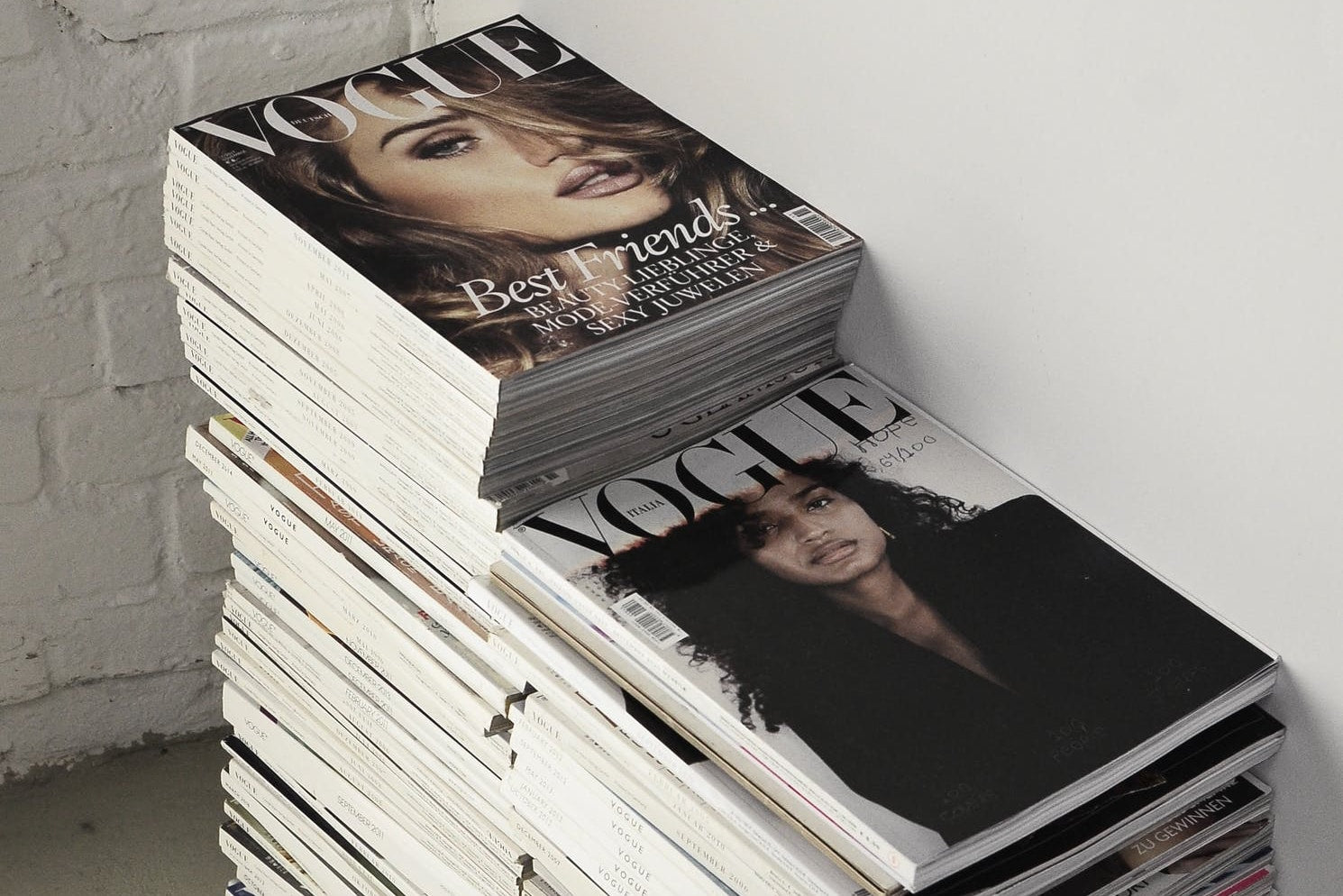 Press page hero image featuring stack of Vogue magazines
